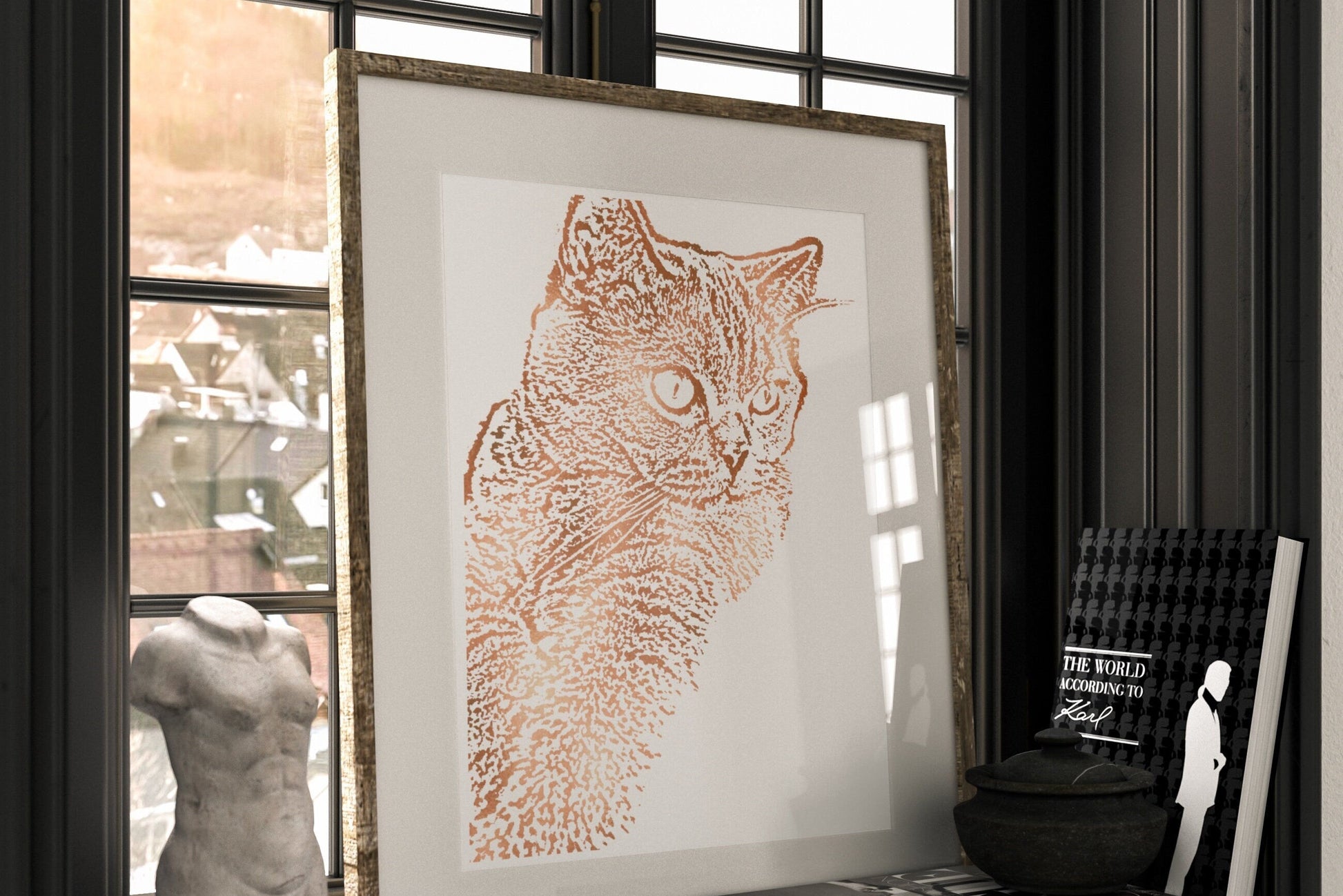 Framed artwork of a cat on a shelf with books and a sculpture.