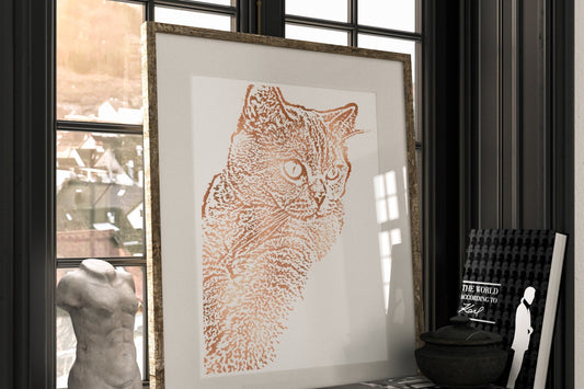Framed artwork of a cat on a shelf with books and a sculpture.